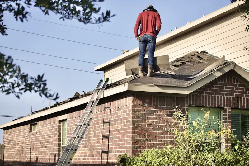 Professional roofer working on a residential roof in Foothills Reserve